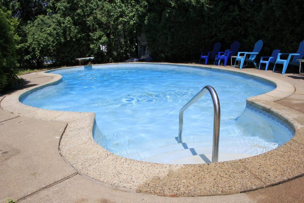 an inground swimming pool in a backyard