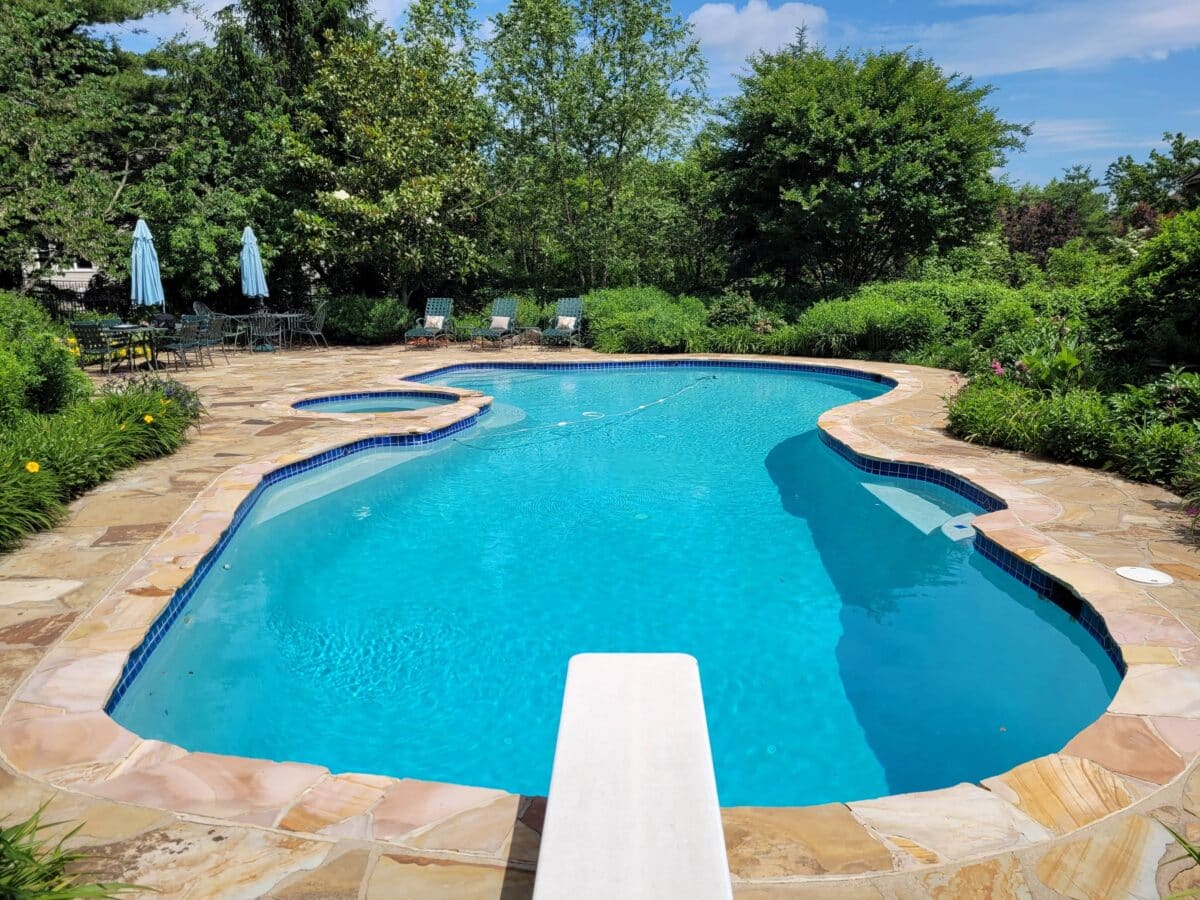 inground swimming pool with a diving board