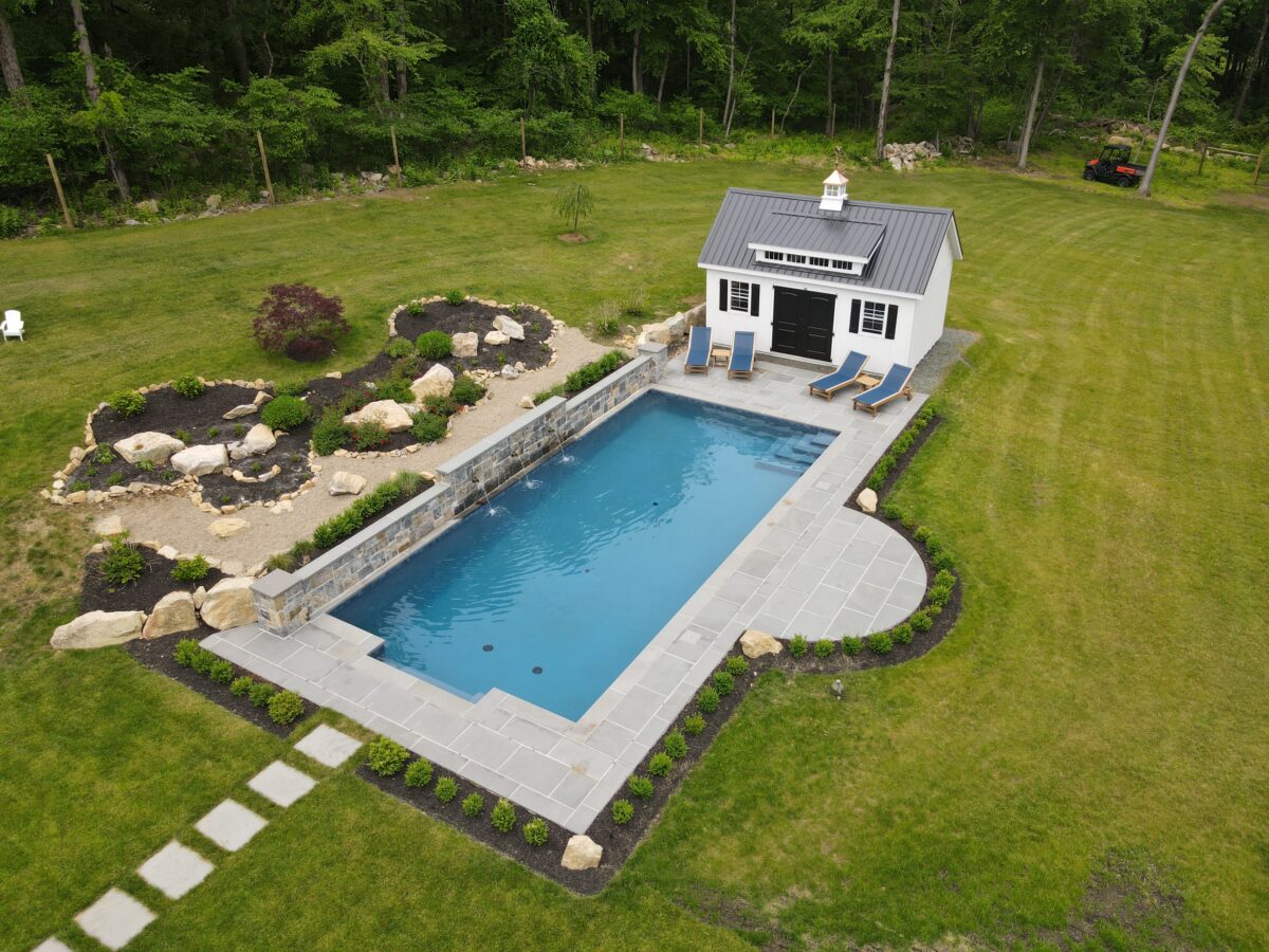 A rectangular inground pool in a yard.