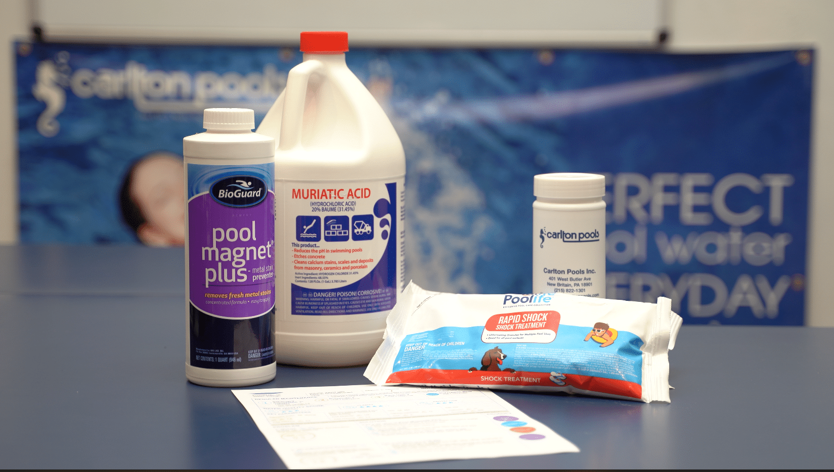 Multiple types of pool chemicals on a table